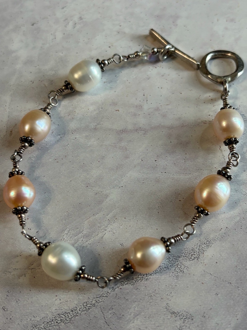 Sterling Silver setting Cultured Pearl Station Bracelet in Cream and Peach.